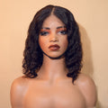 Mannequin head with a black wig on a beige background